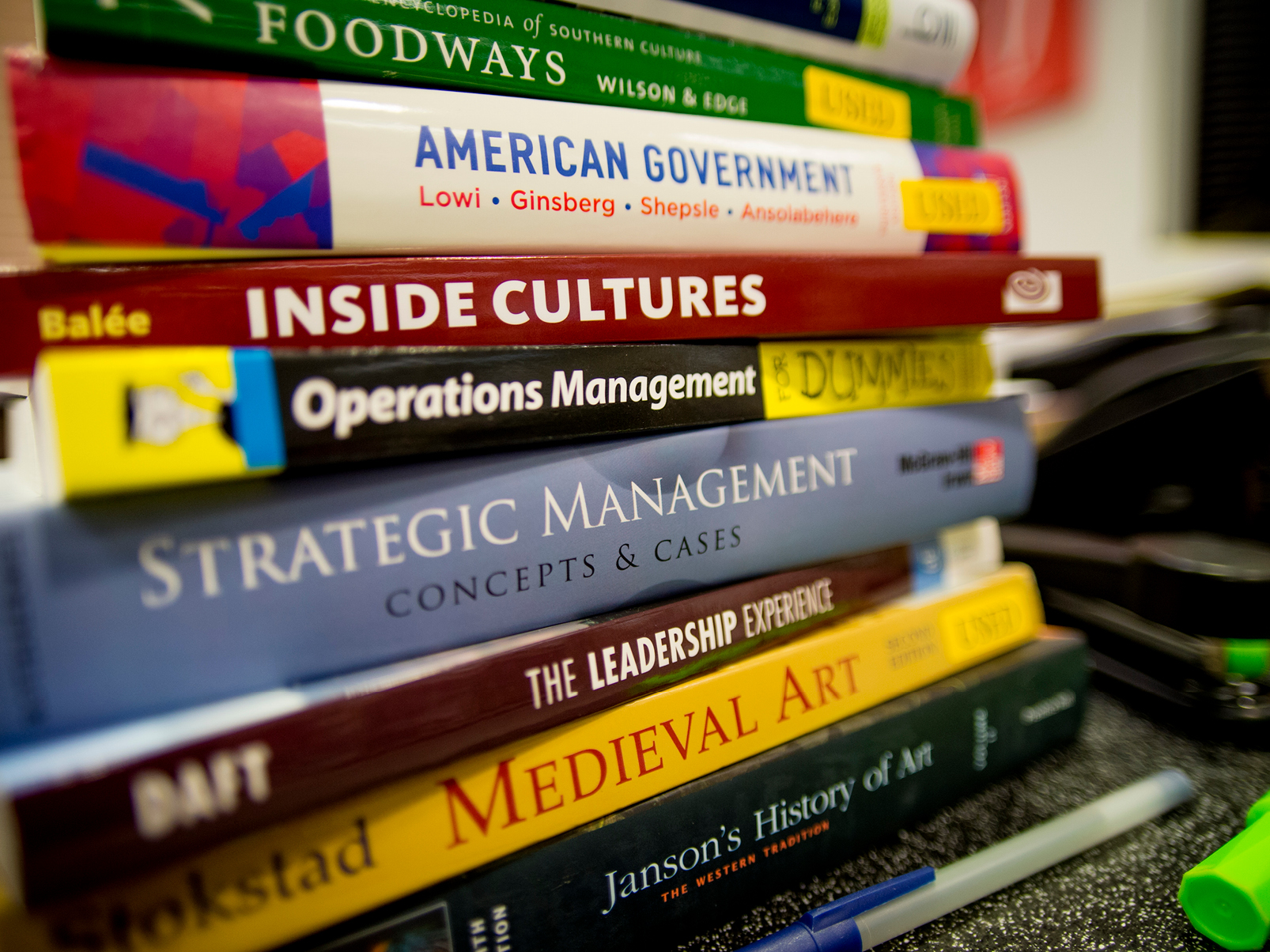 Stack of School of Liberal Arts textbooks.